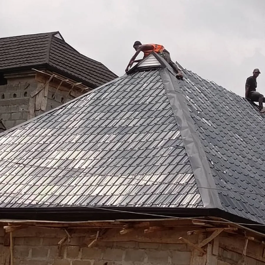 Stone-coated metal tile roof being installed over a new house